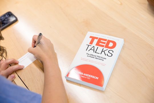 A TED Talks book sites on a table